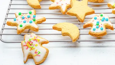 Butterplätzchen liegen auf einem Abkühlgitter. Einige sind mit Zuckerguss und Streusel verziert. - Foto: ShowHeroes für LECKER @ Bauer Media Group Butterplätzchen liegen auf einem Abkühlgitter. Einige sind mit Zuckerguss und Streusel verziert. - Foto: ShowHeroes für LECKER @ Bauer Media Group