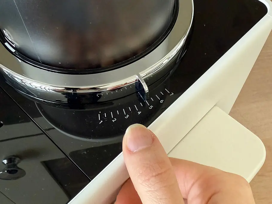 Kaffeevollautomat De’Longhi Rivelia im Test Mahlwerk Den Mahlgrad verstelle ich mit einem Hebel rechts vom Bohnenbehälter
