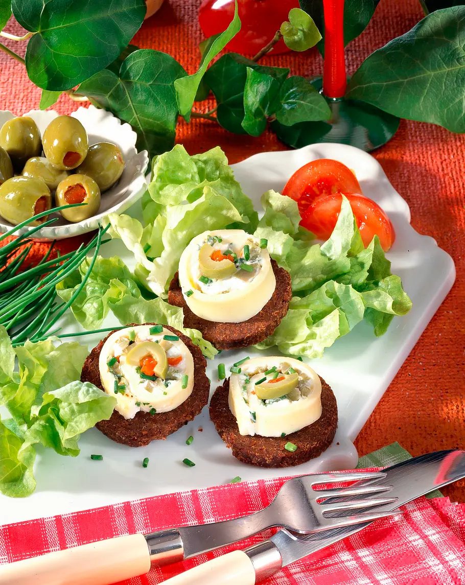 Käseröllchen auf Pumpernickel Rezept Käseröllchen auf Pumpernickel Rezept