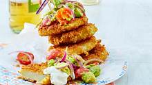Kohlrabischnitzel auf einem Teller getürmt mit Salat aus Avocado, Cherrytomaten und roten Zwiebeln - Foto: House of Food / Bauer Food Experts KG