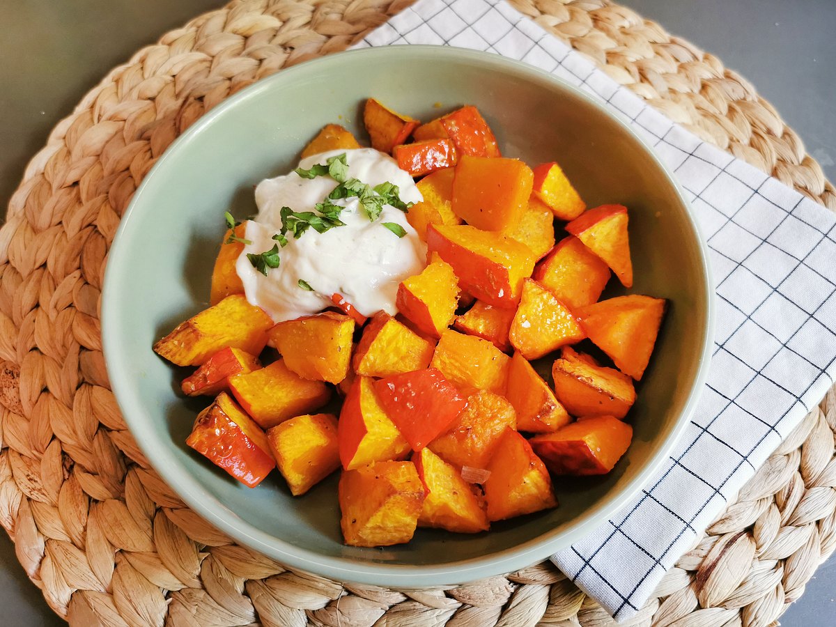 Gewürfelter Hokkaido-Kürbis im Airfryer gegart in einer mintfarbenen Schale mit Joghurt-Dip