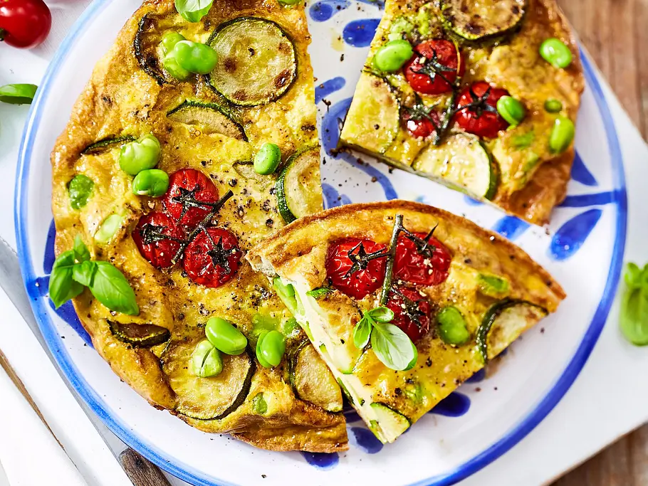 Low Carb-Rezept Airfryer: Zucchini-Tomaten-Frittata Frittata mit Zucchini, Tomaten und Bohnen auf einem Teller serviert.