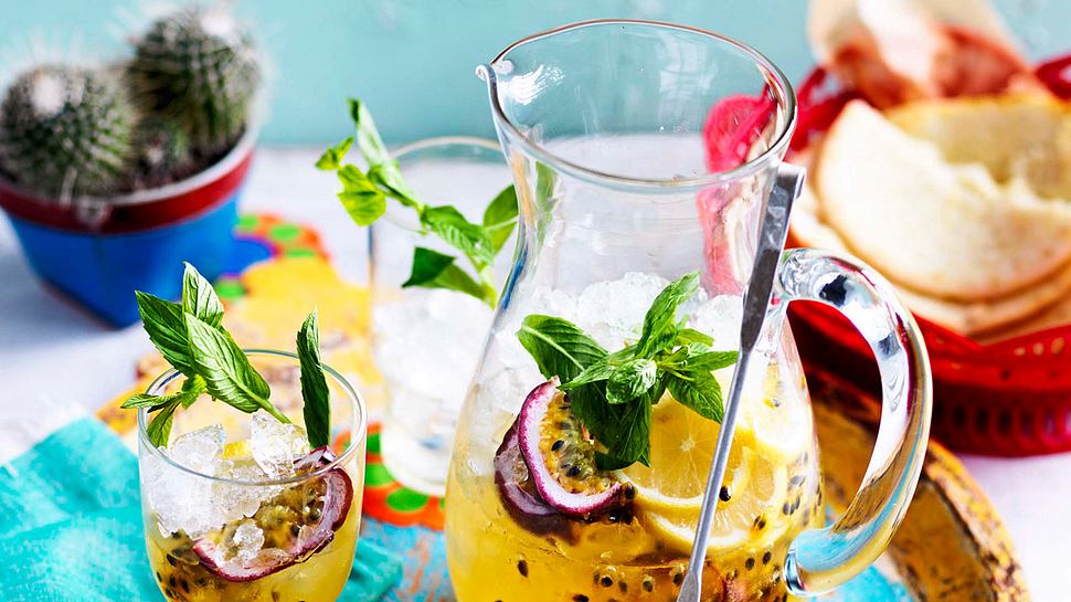 Eine Karafffe und ein Glas gefüllt mit Maracuja-Minz-Spritz auf einem bunten Tablett - Foto: House of Food / Bauer Food Experts KG