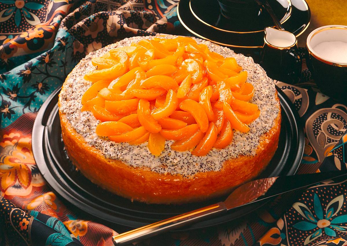 Mohn-Sahne-Biskuittorte mit Pfirsichspalten Rezept