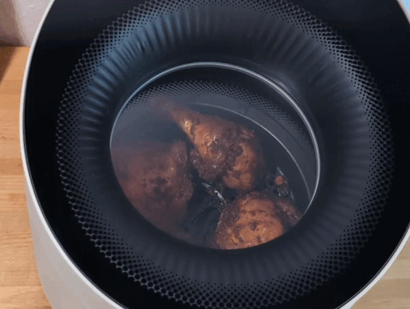 Der Russell Hobbs Satisfry Panoramic Airfryer, von oben gefilmt – mit Blick durch das Sichtfenster auf Geflügel bei der Zubereitung