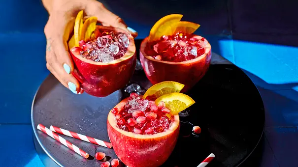 Spiced Apple Sangria mit Granantapfelkernen und Orangenscheiben in drei ausgehöhlten Äpfeln - Foto: LECKER @ Bauer Media Group Spiced Apple Sangria mit Granantapfelkernen und Orangenscheiben in drei ausgehöhlten Äpfeln - Foto: LECKER @ Bauer Media Group