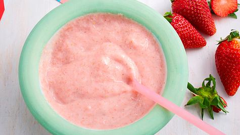 In einer grünen Schale, ist rosaner Erdbeergrießbrei mit einem rosanen Löffel - Foto: StockFood / Gräfe & Unzer Verlag / Bonisolli, Barbara